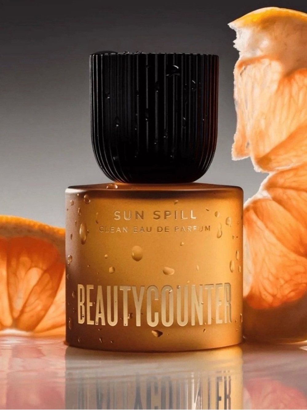 beautycounter Sun Spill Eau de Parfum — Amber Orange Bottle with Black Cap